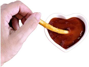 Hand dipping a fry into a heart-shaped bowl